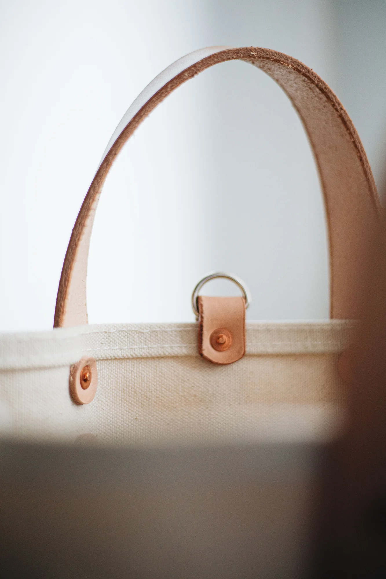 Close-up detail of canvas and leather tote construction